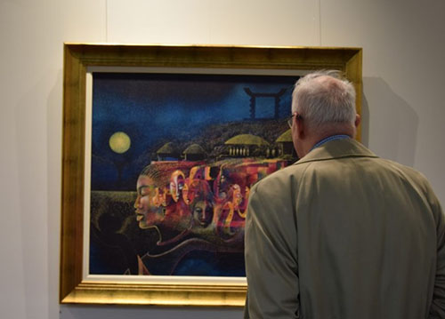 shot of man looking at painting at lifelyn exhibition
